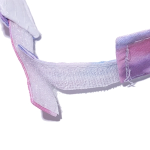 Detail of adjustable velcro strap with pink gradient ink pattern on the sun visor hat