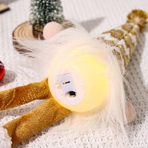 Close-up of the battery compartment and light switch on the base of a Christmas gnome doll