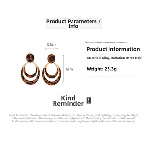 Detailed view of leopard print flocking hoop earrings with 6cm by 3.5cm dimensions
