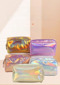 Macro view of assorted iridescent laser makeup bags with metallic zipper finish