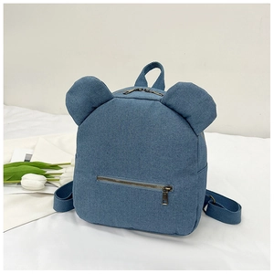 Detail of blue denim mini backpack featuring cute bear ears and metal zipper pocket