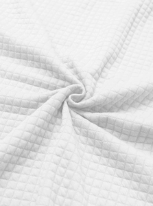Detailed macro view of white waffle knit fabric texture and premium checkered jacquard weave
