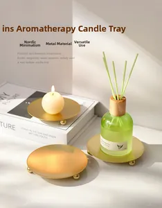 Golden metal candle tray with ball feet in a minimalist Nordic style home setting