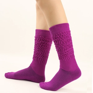 Detail of deep purple slouch socks featuring unique pleated knit texture and elastic design