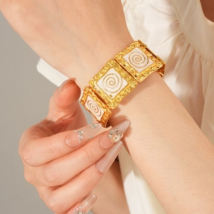 Detail of vintage enamel square bracelet with spiral texture on gold-plated metal