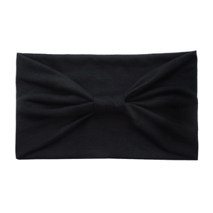 Detail of black elastic cotton yoga headband showing soft fabric texture and central knot