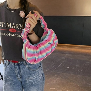 Detail of vibrant rainbow tie-dye shoulder bag featuring premium pleated texture