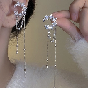 Close-up of silver tassel earrings with flower zircon cluster and hanging beads