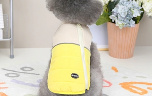 Close-up of yellow and beige quilted pet vest featuring a convenient back zipper design