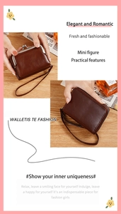 Detail showing vintage brown mini kiss-lock coin purse with wrist strap and smooth finish