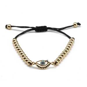 Bracelet perles dorées avec œil en zircon bleu et cordon noir réglable pour femme