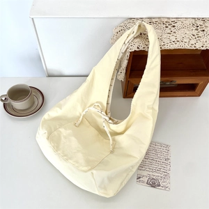 Top-down view of a light yellow corduroy tote bag with front pocket and drawstring detail