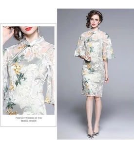 Detail of floral embroidery on light gray lace cheongsam dress with stand collar