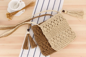 Close-up of hollow crochet star pattern on woven bags with tassels and wooden beads