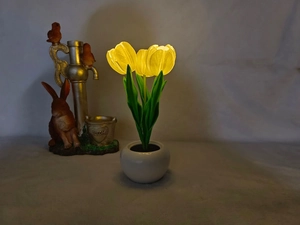 Three-head LED tulip night light with glowing yellow petals and white ceramic base