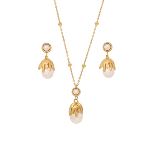 Elegant gold double-layered necklace and drop pearl earrings set on white background