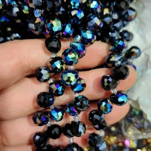 Detail of faceted 6mm dark blue crystal glass beads with iridescent finish for DIY crafts