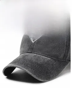 Detail of grey washed baseball cap showing white heart embroidery and curved brim