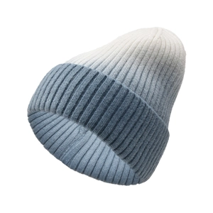 Detail view of the thick ribbed knit texture on a blue gradient winter beanie hat