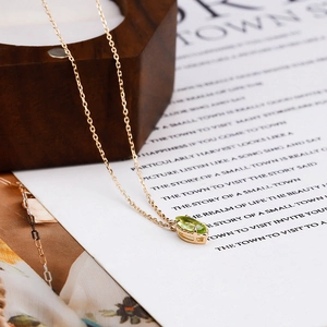 French vintage S925 silver necklace with marquise green gemstone on wood background