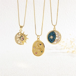 Macro shot of three celestial necklaces featuring moon, sun and star pendants with zircons