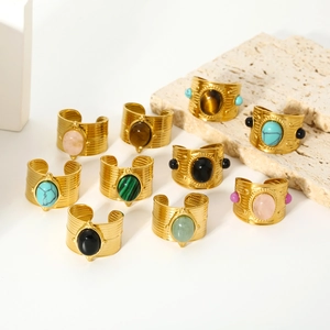 Detail of 18k gold plated stainless steel rings with colorful natural stone inlays