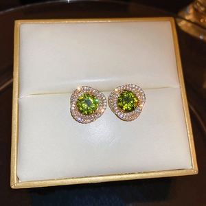 Vintage gold stud earrings with green zircon and micro-inlaid diamonds in jewelry box