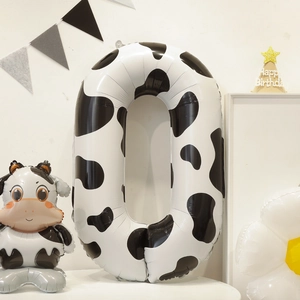 Detail of cow print number 0 foil balloon set for birthday party decorations