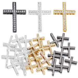 Cross pendant with rhinestones and side heart cutouts in gold, silver, and black finishes