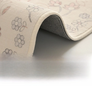 Close-up of double-stitched reinforced edges and non-slip texture on floral rug