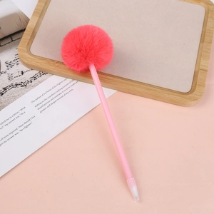 Close-up of pink fluffy pom-pom ballpoint pen on a minimalist tabletop background