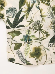 Close-up of floral print fabric with beaded drawstring detail on casual resort trousers