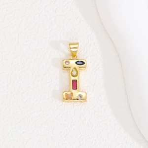 Macro shot of gold letter I pendant featuring colorful zircon stones in various shapes