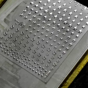 Detailed 3D silver embossed star and dot patterns on professional nail art sticker