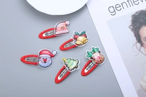 Detail of five-piece red Christmas hair clips set with glitter-filled holiday shapes