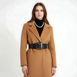 Fashionable black elastic waist belt styled on a camel coat with premium metallic buckle