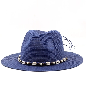 Detailed view of the Panama straw hat featuring natural sea shells and wooden bead accents