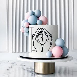 Detail of baby shower cake topper showing a 9.5cm minimalist line art of parent hands