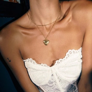Double layered gold titanium heart pendant necklace for women shown on neck collarbone