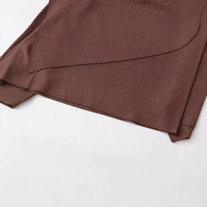 Fashionable loose brown knit cape for women featuring asymmetric layered metallic yarn design