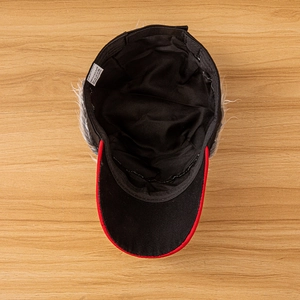 Detailed interior view of a cotton baseball cap featuring internal wig hair and 100% cotton tag
