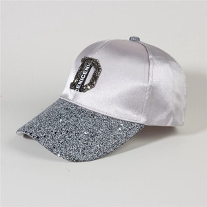 Close-up of lilac satin baseball cap featuring a diamond-studded D and glittery brim