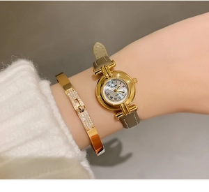 Detailed view of DINIMI elegant women's watch with Roman numerals and grey strap