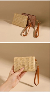 Detail showing the straw woven texture and PU leather wristlet of the mini coin purse