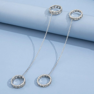 Detail of silver chain ring set with punk style hollow textures on light blue background