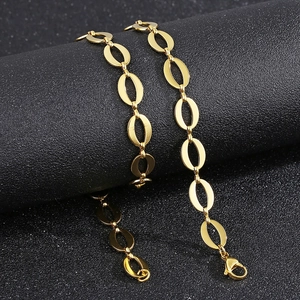 Macro shot of gold stainless steel oval link chain featuring a lobster clasp detail
