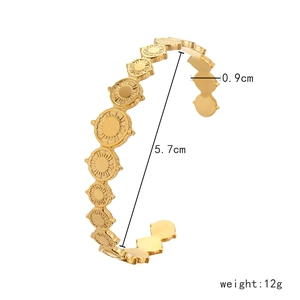 Detail view of gold stainless steel sun coin cuff bracelet with 0.9cm width and 5.7cm diameter