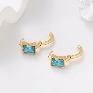 Detail of gold rectangular earrings with clear blue stones and U-shaped clasp