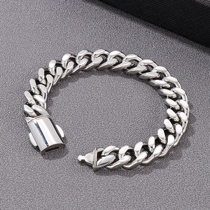 Detailed close-up of polished silver Cuban link chain bracelet with a unique clasp