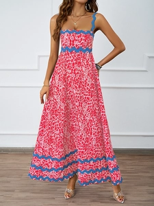 Detail of bohemian leopard print maxi dress with elegant blue wavy trim and flowy fabric